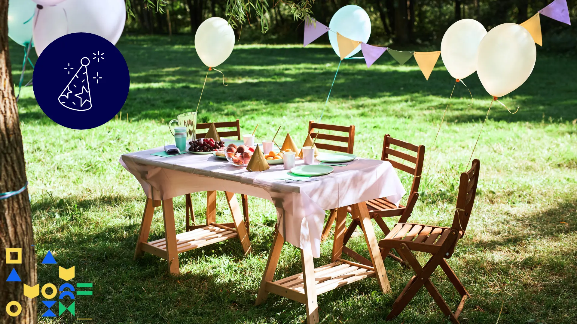 Image of a wood table and chairs outdoors in a yard with balloons and banners and party hats and food representing an affordable kid's birthday party